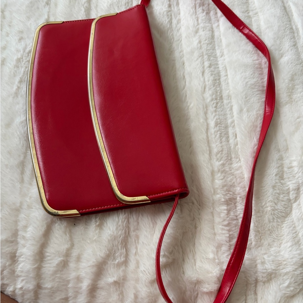 Vintage Red envelope style Bag with Gold trim. Strap is 36”